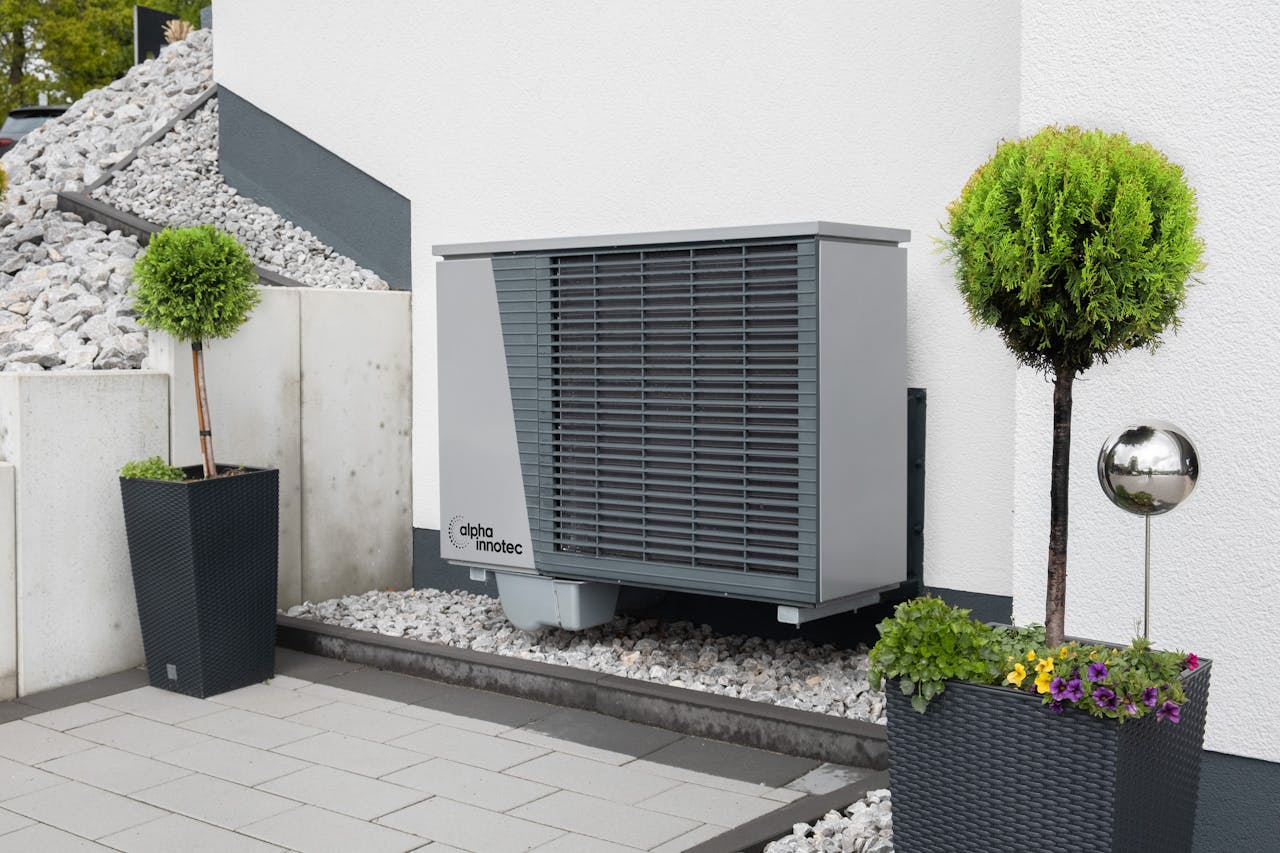Modern air conditioning unit with flower pots and sleek decor outdoors.